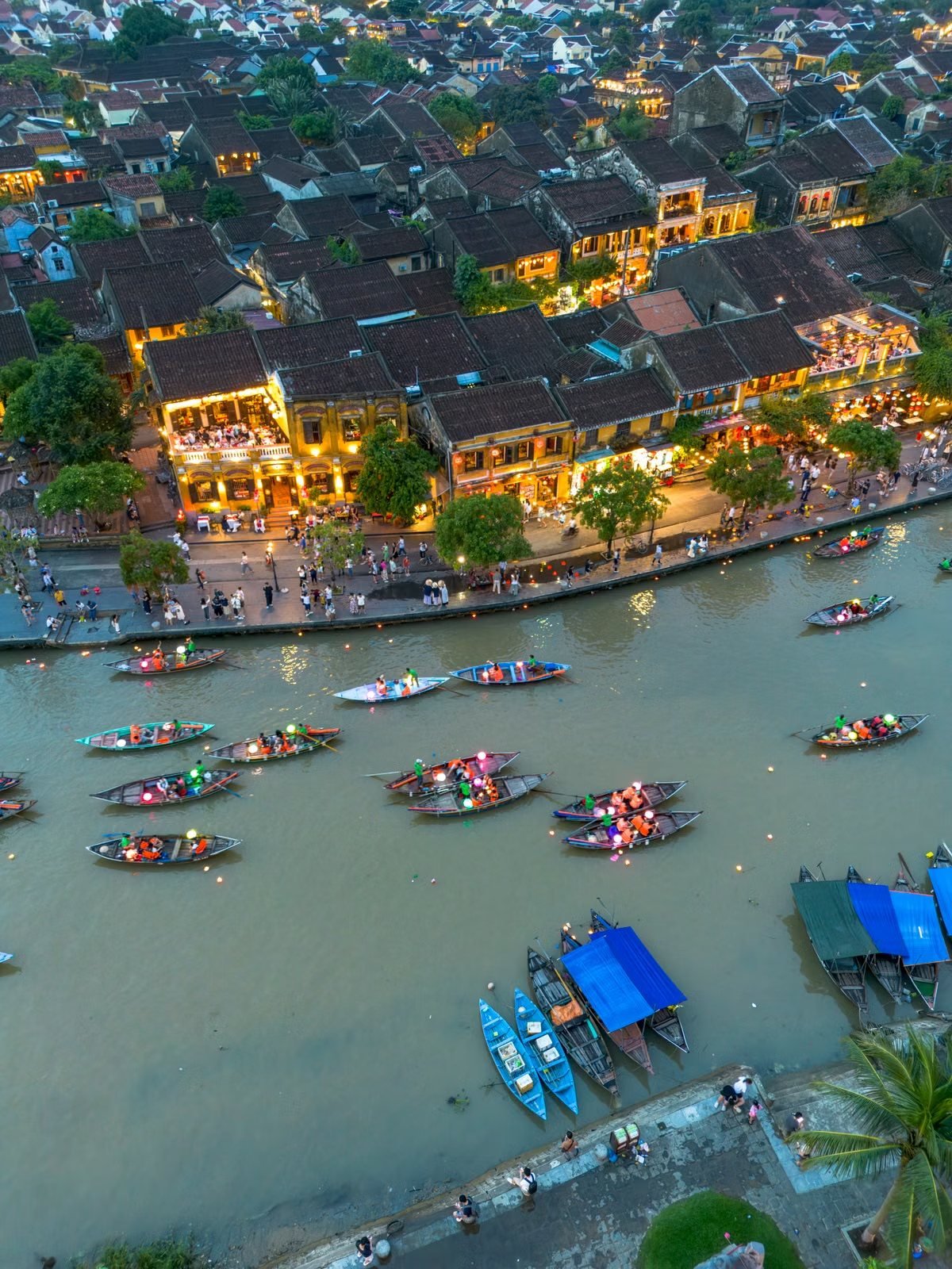 Hoi An old town and lantern boats on the river at dusk